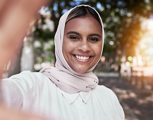 Image showing Selfie, happy and portrait of Muslim woman in park for holiday, freedom and relax outdoors. Social media, hijab and face of Islamic female person with smile for picture, memories and post in nature