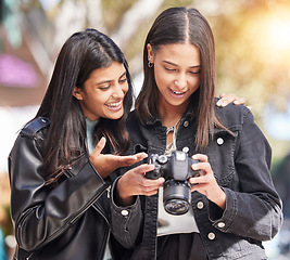 Image showing Photography camera, city and happy friends check photo, picture or urban photographer, women or tourist shooting. Creative photoshoot, sidewalk and gen z youth, students or young people analyse shot