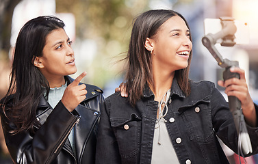 Image showing Pointing, selfie and direction with friends in city for social media, happy and support. Happiness, profile picture and live streaming with women in outdoor for internet, post and youth together