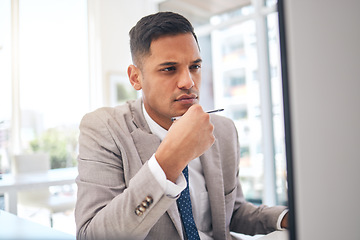 Image showing Thinking, business man and planning at computer for research analysis, reading data information and problem solving. Male employee focus at desktop for website solution, decision and choice of ideas