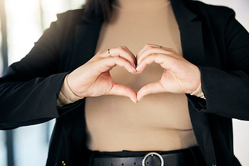 Image showing Closeup of a businesswoman with a heart shape in the office for care, support and valentines day. Zoom of a professional female person with a love hand gesture, sign or emoji in the workplace.
