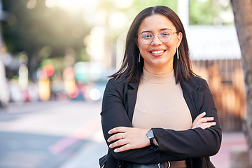 Image showing Portrait, designer and woman with arms crossed in city, urban street or outdoor. Face, glasses and confidence of creative professional, employee smile and happy worker from Brazil for business career