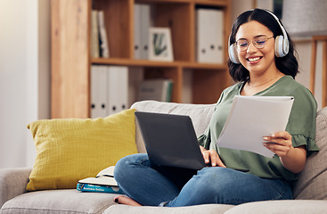 Image showing Laptop, documents and remote work with a freelance woman working online for a business startup. Computer, music and headphones with a happy young female entrepreneur reading information in her home