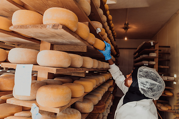 Image showing Arab investor in a warehouse of the cheese production industry