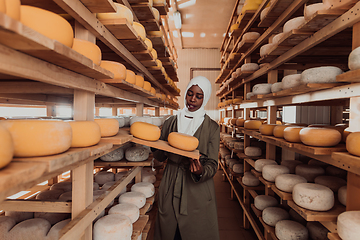 Image showing Arab investor in a warehouse of the cheese production industry