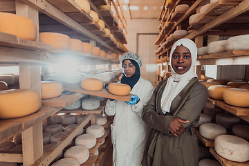 Image showing Arab business partner visiting a cheese factory. The concept of investing in small businesses