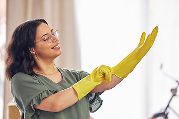 Image showing Woman, hand and gloves for cleaning service in home for safety from germs, bacteria in living room. Happy, girl and disinfect in apartment for dirt with household maintenance for dust or virus.