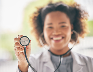 Image showing Healthcare, stethoscope and cardiology with a doctor in the hospital for a routine checkup during an appointment. Medical, hand and heart health with a woman medicine professional in a clinic