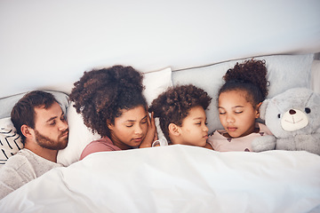 Image showing Sleeping, above and family in a bed with love, dreaming and resting in their home cosy together. Sleep, top view and children with parents in a bedroom nap, peaceful and hugging, comfort and bond