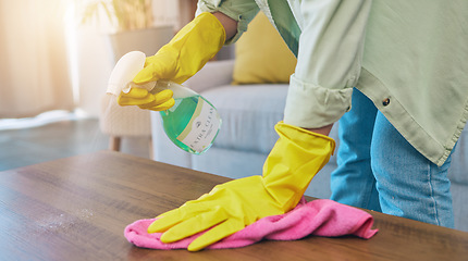 Image showing Woman, hands and cleaning table with spray for housekeeping, hygiene or bacteria removal at home. Female person or cleaner spraying chemical bottle for germs, dirt and wiping wooden desk or furniture