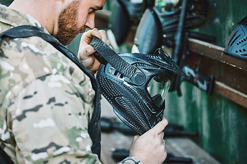 Image showing Army, helmet and a man with gear for paintball, military training or start of a fitness challenge. Tools, sports and a person or soldier with a mask for hero game, battle or exercise by a field