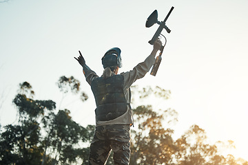 Image showing Paintball game, victory and woman celebration, cheers or excited for battlefield success, army training event or achievement. Fun mission winner, nature sky and back of person with competition win