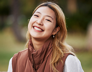 Image showing Happy, smile and portrait of Asian woman in park for holiday, freedom and relaxing outdoors. Happiness, nature and face of female person with joy, confidence and positive mindset for travel in summer