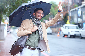 Image showing Happy man, umbrella and taxi in city for travel, lift or pick up and waiting on sidewalk of road in rain. Male person waving hand for signal, trip or ride service by street in winter of an urban town