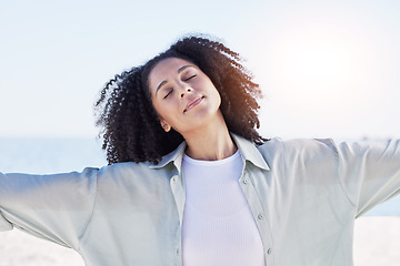 Image showing Woman at beach, freedom and travel with peace outdoor, mindfulness and calm with sunshine and fresh air. Young female person, carefree and zen with wellness, nature and summer with adventure