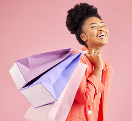 Image showing African woman, studio and smile shopping bag with discount, sale and thinking by pink background. Young gen z girl, retail promotion and happy for deal, customer experience and fashion for gift idea
