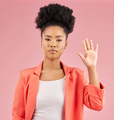 Image showing African woman, hand and stop in portrait, studio or opinion for protest, vote or icon by pink background. Girl, open palm and sign language with voice, emoji and afro with review, feedback or warning