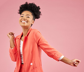 Image showing Happy, dance and portrait of a woman in a studio with music, playlist or album for celebration. Happiness, smile and young African female model moving to a song isolated by a pink background.