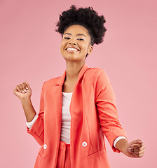 Image showing Smile, dancing and portrait of a woman in a studio with music, playlist or album for celebration. Happiness, excited and young African female model moving to a song isolated by a pink background.