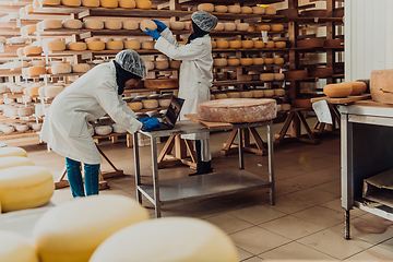 Image showing Muslim business partners checking the quality of cheese in the modern industry