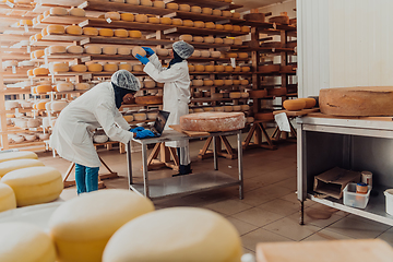 Image showing Muslim business partners checking the quality of cheese in the modern industry