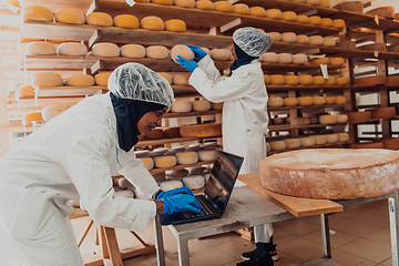 Image showing Muslim business partners checking the quality of cheese in the modern industry