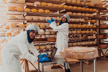 Image showing Muslim business partners checking the quality of cheese in the modern industry