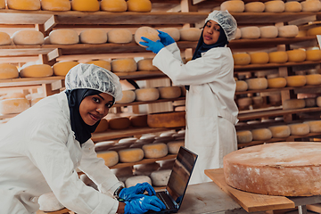 Image showing Muslim business partners checking the quality of cheese in the modern industry