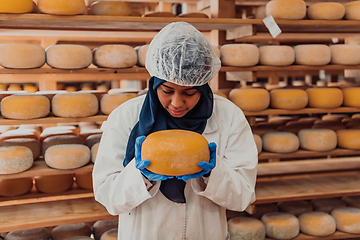 Image showing Arab investor in a warehouse of the cheese production industry