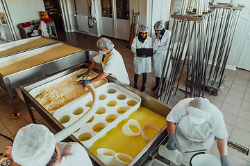 Image showing Arab business partners oversee cheese production in modern industry