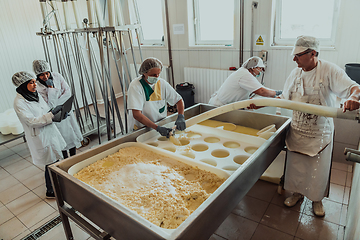Image showing Arab business partners oversee cheese production in modern industry