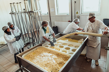 Image showing Arab business partners oversee cheese production in modern industry