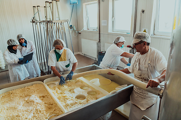 Image showing Arab business partners oversee cheese production in modern industry