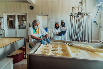 Image showing Arab business partners oversee cheese production in modern industry