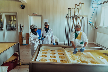 Image showing Arab business partners oversee cheese production in modern industry