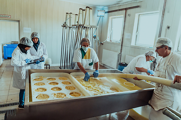 Image showing Arab business partners oversee cheese production in modern industry