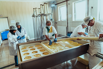 Image showing Arab business partners oversee cheese production in modern industry