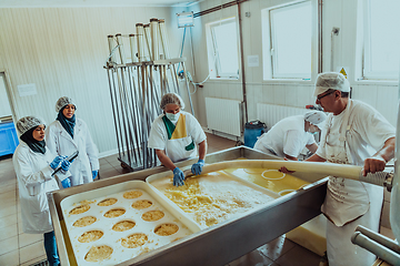 Image showing Arab business partners oversee cheese production in modern industry