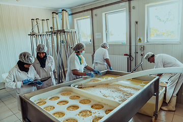 Image showing Arab business partners oversee cheese production in modern industry