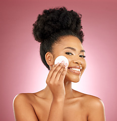 Image showing Black woman, cotton pad and skincare with makeup, portrait and facial on a studio background. Female person, face and happy model with cosmetics, aesthetic and cleaning with patches, shine and glow