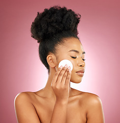 Image showing Black woman, cotton pad and dermatology with makeup, facial and salon treatment on a studio background. Female person, shine or model with cosmetic tools, glow and cleaning with patches and aesthetic