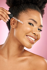 Image showing Black woman, portrait and serum for face in studio, aesthetic skincare and dermatology on pink background. Happy female model, facial cosmetics and dropper of hyaluronic acid, oil and beauty collagen