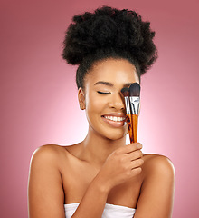 Image showing Makeup, smile and black woman with brushes, facial and dermatology against a studio background. Female person, aesthetic and happy model with cosmetic tools, natural beauty and grooming with skincare