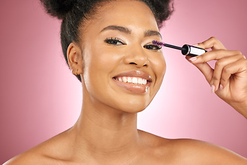 Image showing Makeup, mascara and beauty portrait of a woman for skincare, wellness and dermatology glow. Happy, eyelash and face cosmetics of a black female model with facial shine on a pink background in studio