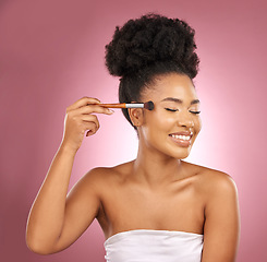 Image showing Makeup, smile and black woman with brushes, beauty and dermatology against a pink studio background. Female person, skincare or happy model with cosmetic tools, aesthetic and grooming with self care