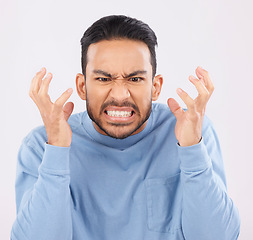 Image showing Mental health, anger and mad with a frustrated man in studio on a gray background feeling stress. Face, psychology and emotions with a young male person looking annoyed while gritting his teeth