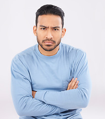 Image showing Portrait, angry and man with arms crossed, frustrated and upset guy against a white studio background. Face, male person and model with anger, expression and frustration with emotion and conflict