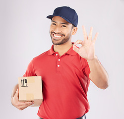 Image showing Courier man, ok sign and studio portrait with box, delivery, opinion or good service by white background. Supply chain manager, happy or review with like icon, emoji and hand with cardboard package