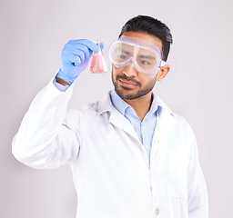 Image showing Scientist man, studio and beaker with goggles, thinking or analysis for focus by white background. Asian science expert, glass container and chemistry innovation with idea, ppe or study at pharma job