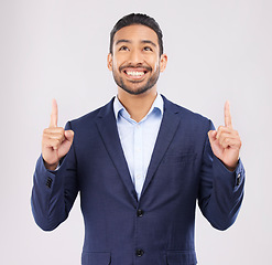 Image showing Smile, hand pointing and asian man in studio with sale, announcement or coming soon promo on grey background. Happy, news and Japanese male show launch, platform and giveaway, process or review info